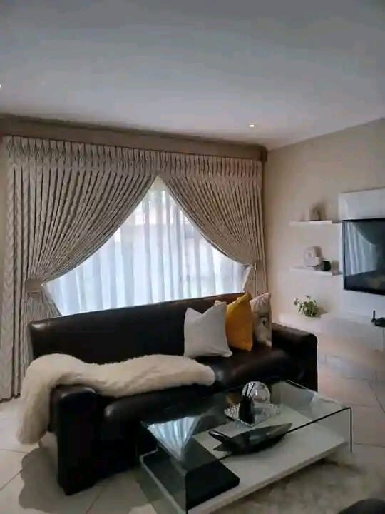 Pleated curtains finishing a lounge, fitted by Chiwondo Home Choice